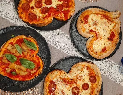 Four heart-shaped pizzas.