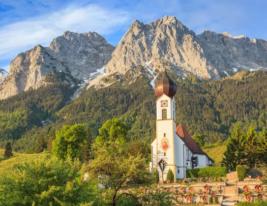 Church building with grassy mountain in the foreground