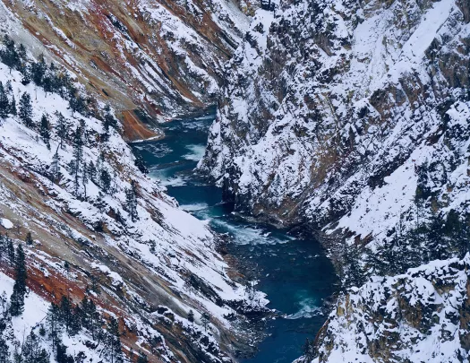 Snow covered mountains and rushing river