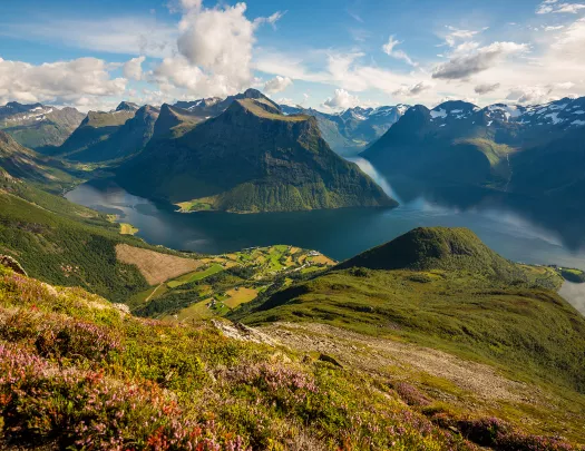 Large valley with grassy mountains and a lake in the center