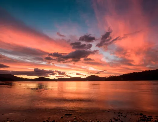 Sunset at the beach with purple and pink clouds