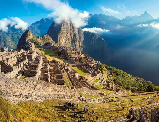Bird's eye shot of Machu Picchu, large group of people in foreground.