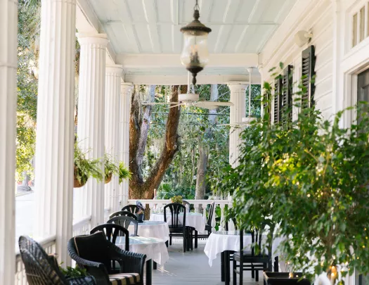 Shot of southern style home deck, chairs all around.