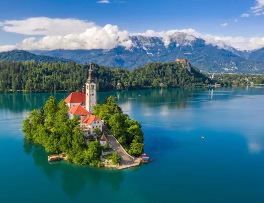 Church on island in center of blue lake.