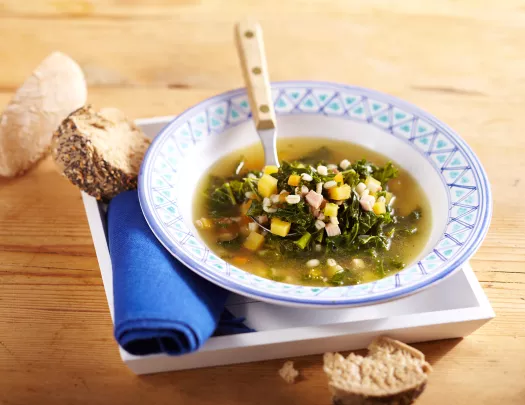 Bowl of vegetable soup and bread.