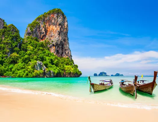 Boats resting on a sandy beach in Thailand
