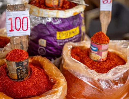 Bags of chili powder with cans for scooping on top