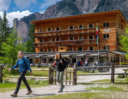 Exterior view of wooden hotel building with two women in front walking