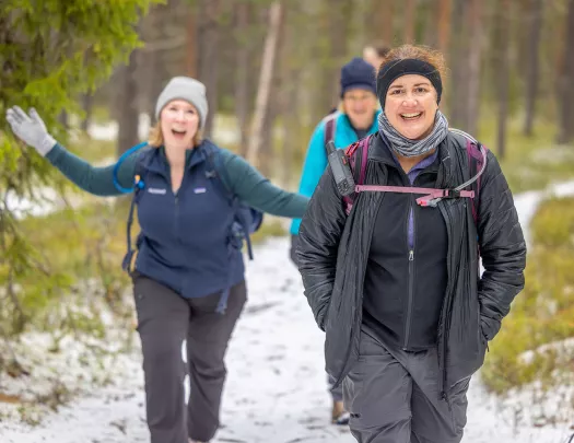 Group of women walking along a snowy trail