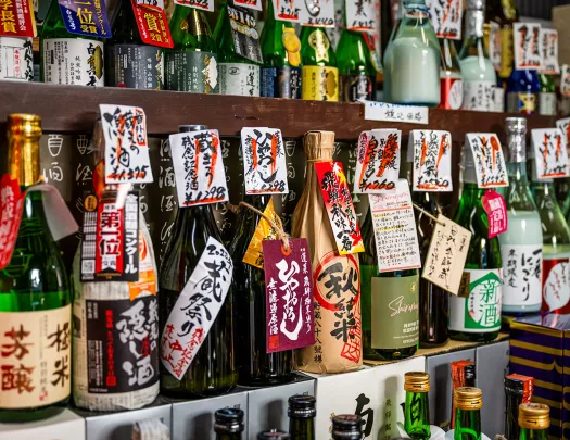 Bottles of alcohol lined up against a wall