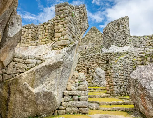 Stone ruins of an ancient town, with stone steps covered with grass
