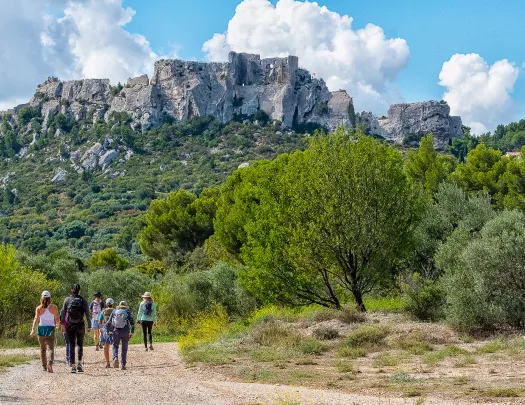 Backroads Guests Walking Towards Rock Formation in Mountain