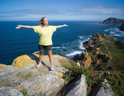 A person standing on top of a rock