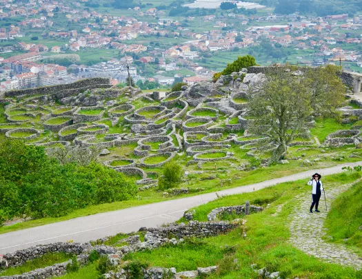 Hiker on Camino de Santiago with town in the backround