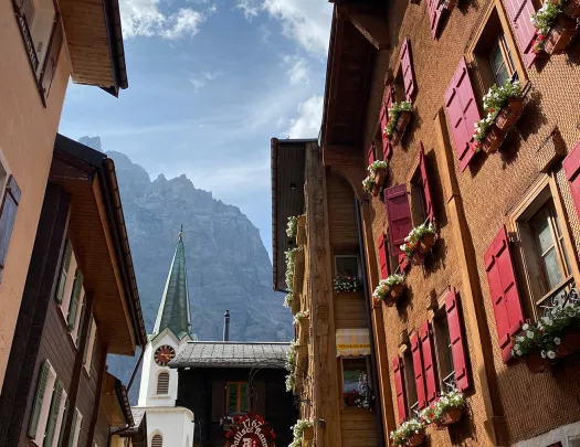 Point of view shot of Swiss alleyway, looking up towards moiuntains. 