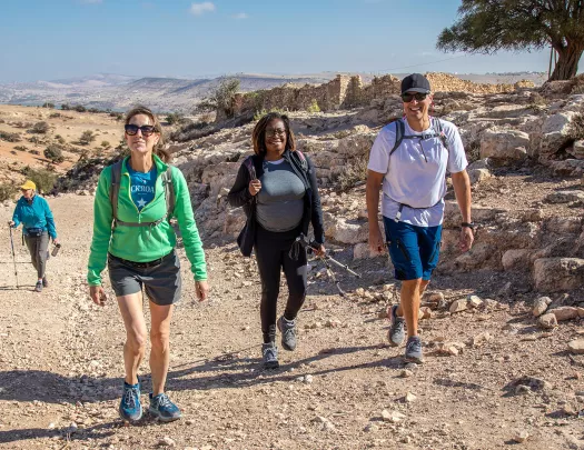 Hikers smiling at camera along trail