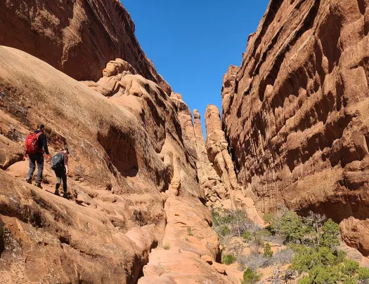 Hikers climbing boulders