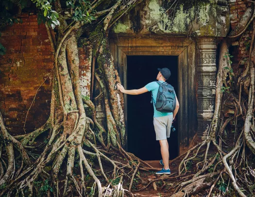 Person exploring the temple of Angkor Wat in Cambodia