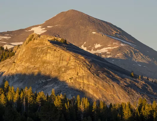 Wide shot of semi-snowy mountain.