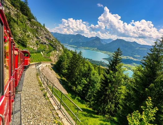 Alps with lush fields and green forests. View of lake Wolfgangsee.